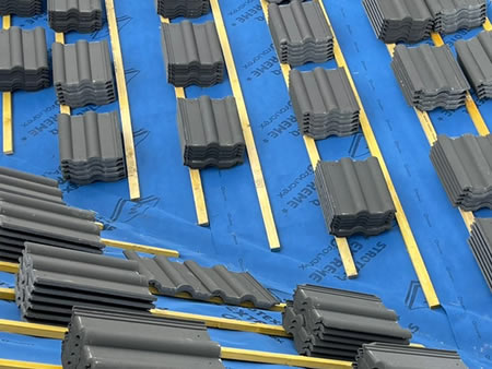 HTS Roofing and Building team re-tiling a pitched roof